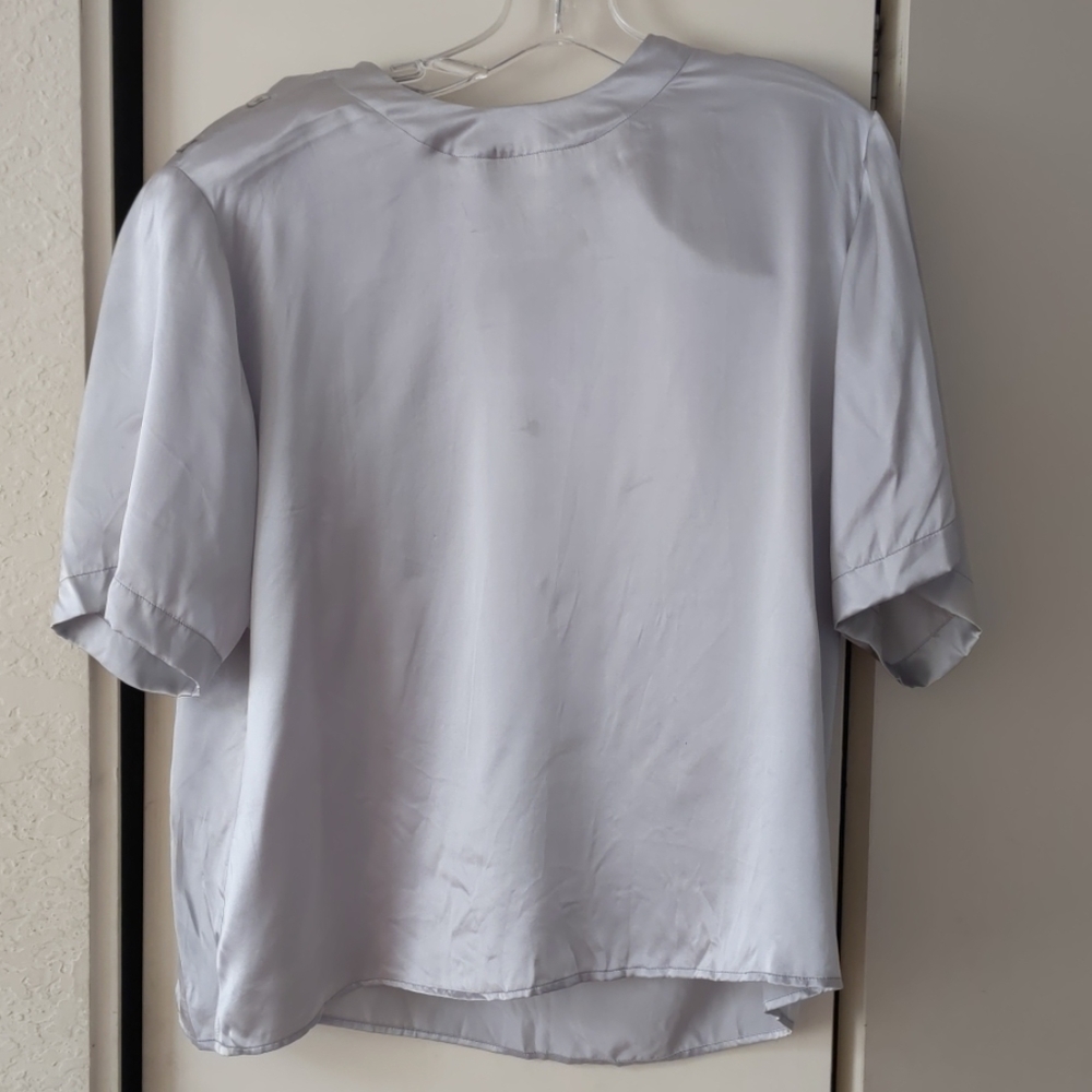 Short sleeves silver silk blouse.